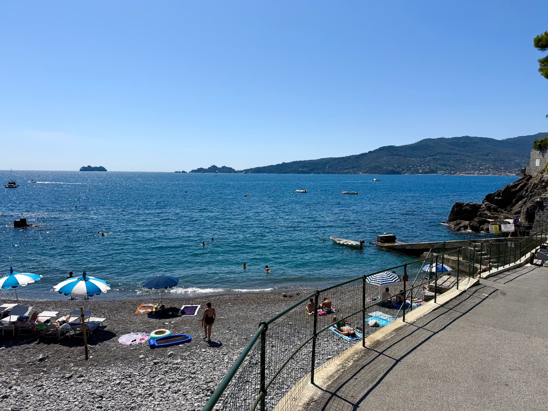Pebble beach and turquoise sea below Villa Maria Luisa