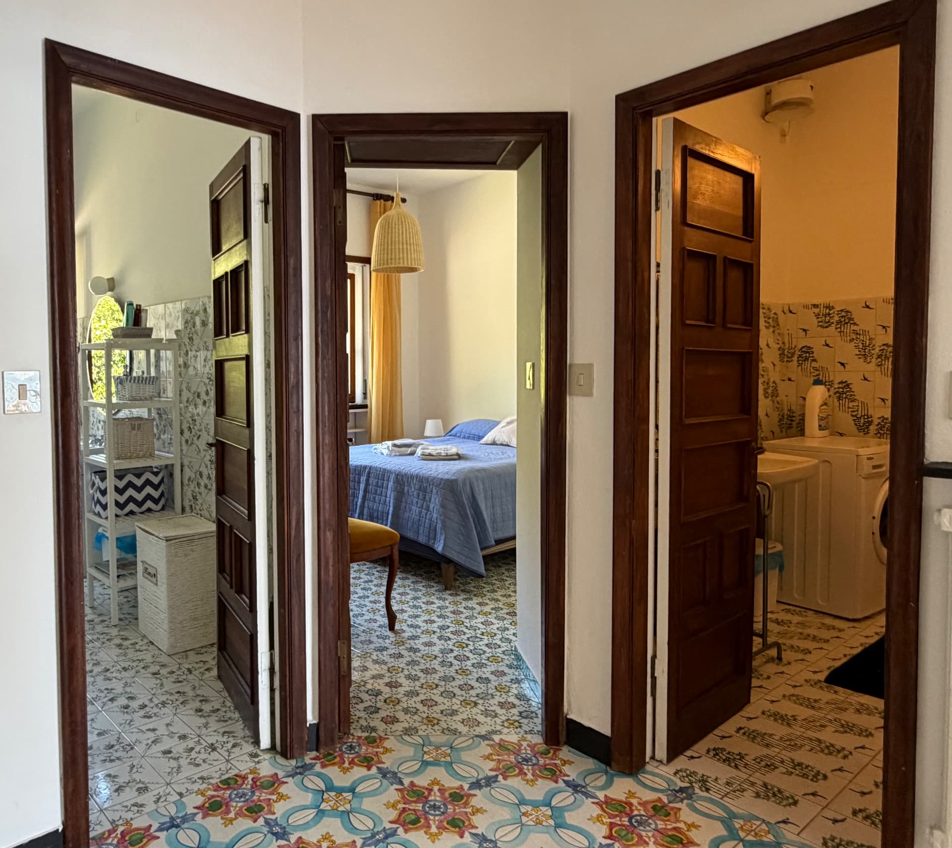 Central hallway with arched doorways and patterned floor tiles